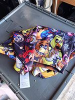 Hoodie folded showing vibrant character print and care tag