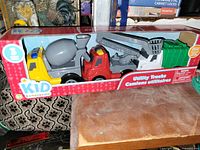 Front view of Kid Connection Utility Trucks 3-piece toy set in retail box