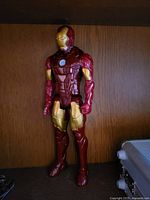 Front view of Iron Man action figure standing on shelf