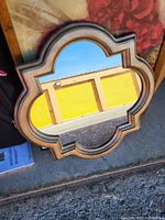 Front view of quatrefoil wall mirror showing frame finish and glass condition