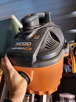Orange and black RIDGID portable wet/dry vacuum showing 5.0 Peak HP label and front hose port