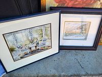 Both framed prints side by side showing artwork, mats, and frame styles