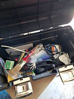 Open toolbox showing assorted tools and hardware