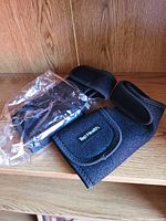 Both wrist braces shown, one sealed in plastic bag and one open displaying Top Health logo