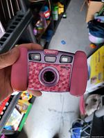 Front view of VTech Kidizoom Plus pink camera with heart pattern and controls visible