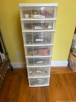 full view of seven-drawer plastic tower with contents visible