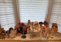 Wide shot of entire doll collection on window sill