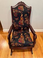 Full front view of rocking chair showing frame, upholstery and legs