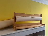 Front view of wooden dispenser with craft paper roll