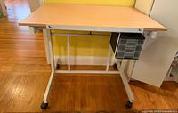 Front view of craft station showing tabletop, frame, casters and drawers