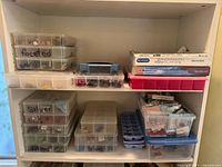 Overview of shelves with multiple labeled bead organizers and catalogs