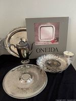 Group shot showing all silver plate items including Oneida boxed tray, teapot, platters, bowl, tongs
