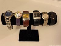 Full view of all six wristwatches on stand