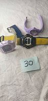 All three wristwatches laid out on fabric surface