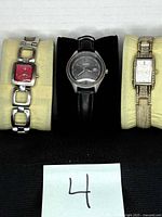 Three Fossil watches side by side on cushions