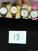 Four watches lined up showing faces and straps