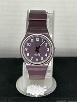 Front view of purple Swatch showing dial and strap