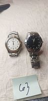 Both wristwatches side by side showing dials and bracelets