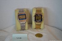 Front view of both digital watches on stands