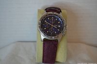 Front view of Cardinal chronograph watch on display pillow