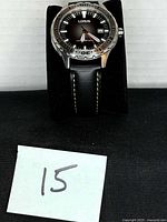 Front view of Lorus watch on display stand showing dial, bezel, and strap