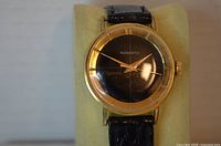 Front view of watch showing dial, case, and strap