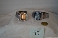 Front view of both digital watches on fabric backdrop