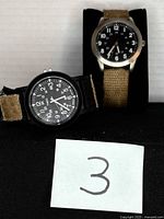 Both watches front view with lot number card