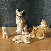 Group shot of all four cat figurines on tabletop