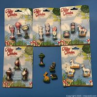All five sealed blister packs and four loose figurines displayed on blue background