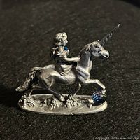 Right side view of pewter maiden on unicorn with blue crystal accents