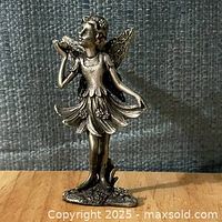 Front view of pewter fairy figurine showing pose, dress, and base