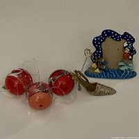 Group shot showing all items: three Umbra Fotoball spheres, Disney frame, glitter shoe