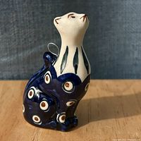 Front angled view of glazed Polish ceramic cat figurine