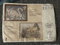 Front of sealed kit with branding, model number 1349, image of finished swan design, finished size 12x16 noted