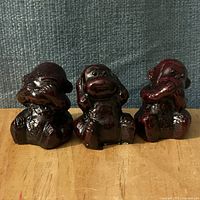 Front view of three resin monkey figurines in traditional see-hear-speak poses