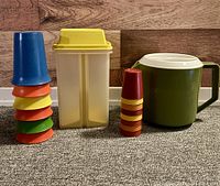 All items in lot: pitcher, divided container, two stacks of tumblers