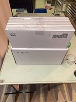 Stack of packaged IKEA BLÅSER mirrors on table