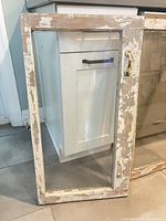 Wood window frame with glass, chippy paint, metal handle