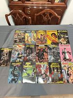 Overhead view of all 16 trade paperbacks laid out in four-by-four grid