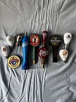 Full set of ten beer tap handles laid out side by side