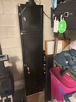 Full view of tall black metal cabinet