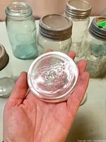 Close-up of embossed Crown glass lid with zinc band