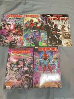 Front covers of five Deadpool trade paperbacks