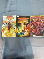 Front covers of the three Deadpool trade paperbacks