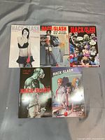 Five Hack/Slash trade paperbacks laid out front covers visible