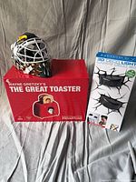 Boxed Wayne Gretzky toaster, loose mini goalie mask, boxed puck lights