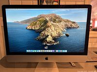 Front view of powered-on 27-inch iMac showing Catalina desktop