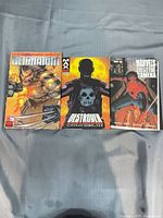 Front covers of three Marvel hardcover graphic novels