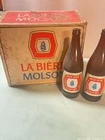 Cardboard Molson Export case and two bottles front view